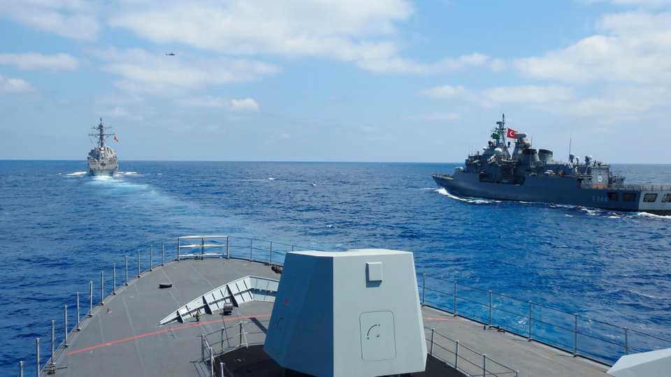 US destroyer USS Winston S Churchill (rear left), along with Turkish frigate TCG Barbaros (front) and TCG Burgazada corvette (right), conduct maritime trainings in the eastern Mediterranean on August 26, 2020.