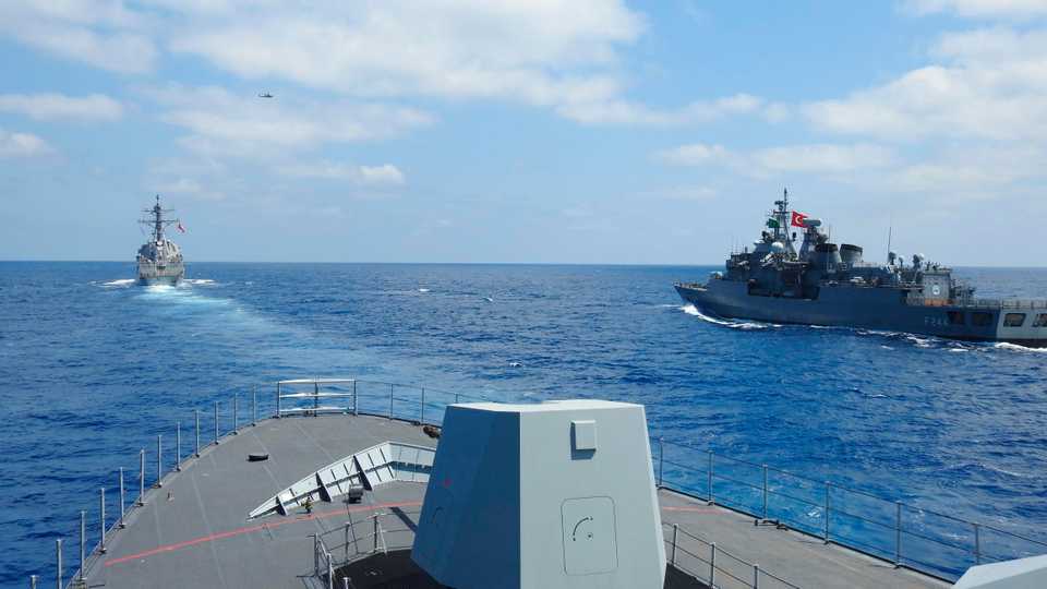 US destroyer USS Winston S Churchill, rear left, along with Turkish frigate TCG Barbaros, front, and TCG Burgazada corvette, right, conduct maritime trainin in the eastern Mediterranean, August 26, 2020.