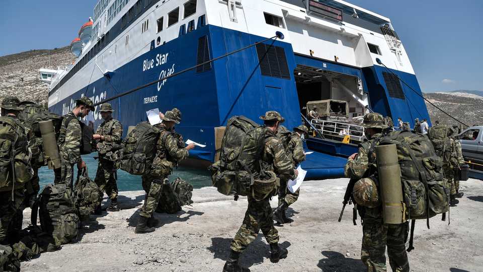 Greek soldiers prepare to board a ferry at the port of the tiny Greek island of Kastellorizo also known as Meis, situated two kilometres off southern Turkey, on August 28, 2020.
