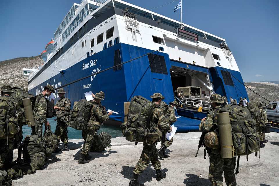 Greek soldiers prepare to board a ferry at the port of the tiny Greek island of Kastellorizo also know as Meis, officially Megisti, the most southeastern inhabited Greek island in the Dodecanese, situated two kilometers off the south coast of Turkey on August 28, 2020.