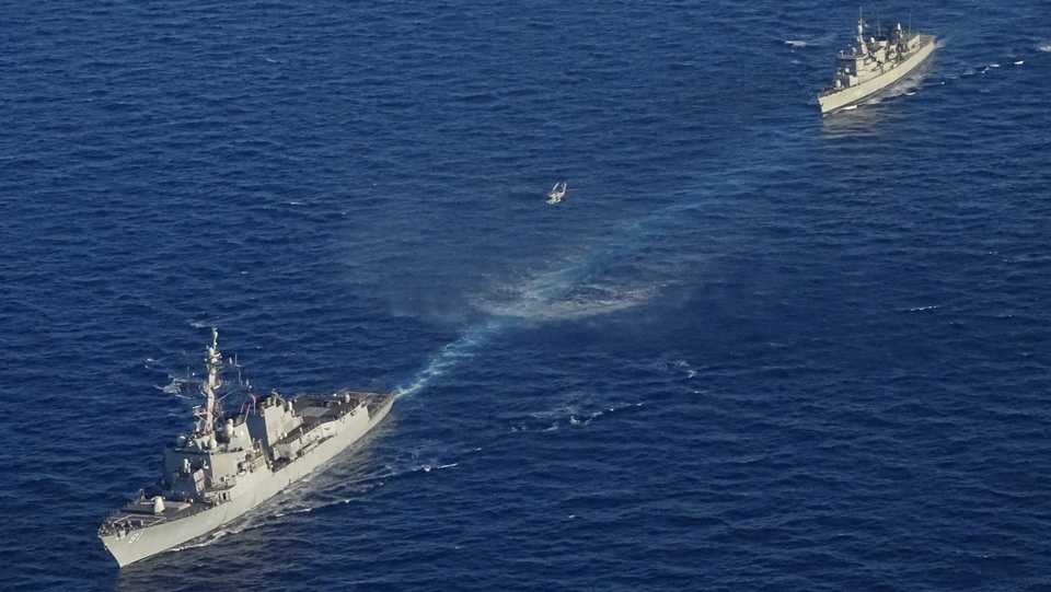 In this photo provided by the Greek National Defense Ministry, warships take part in a Greek-US military exercise south of the island of Crete, August 24, 2020.