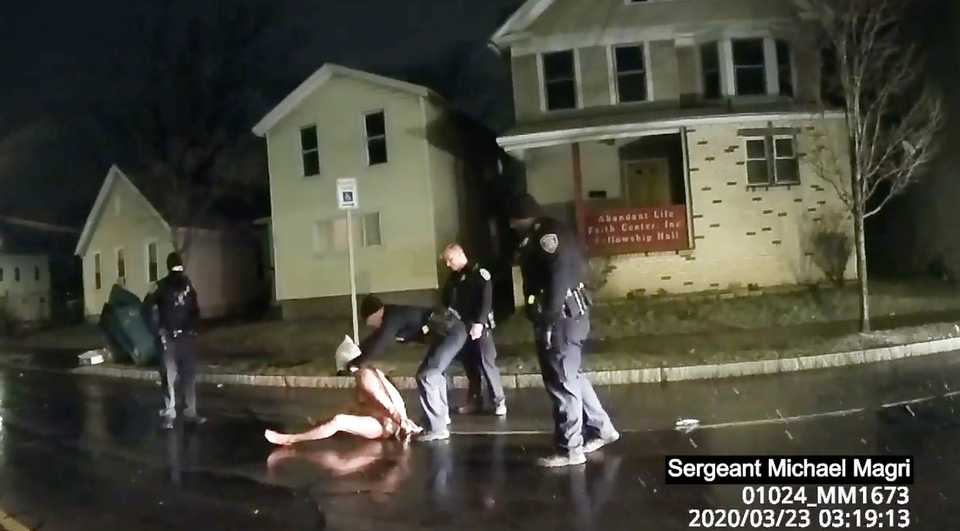 In this image taken from police body camera video provided by Roth and Roth LLP, a Rochester police officer puts a hood over the head of Daniel Prude, on March 23, 2020, in Rochester, NY.