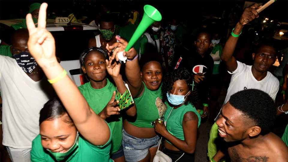 Jamaica Labour Party supporters celebrate the party's win over the People's National Party in St Catherine during the general election on September 3, 2020.