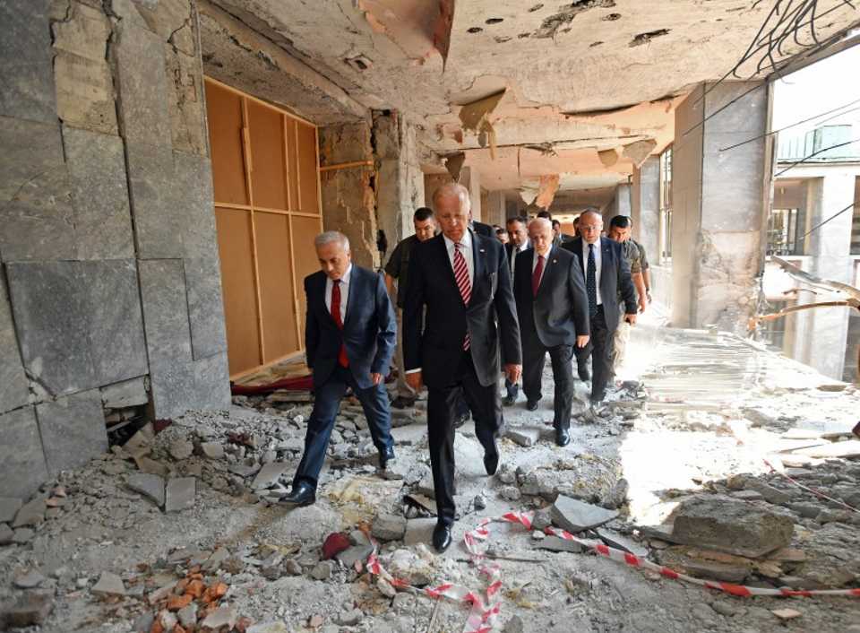 Joe Biden, then Vice President of the United States, inspects bomb damage at the Grand National Assembly. 