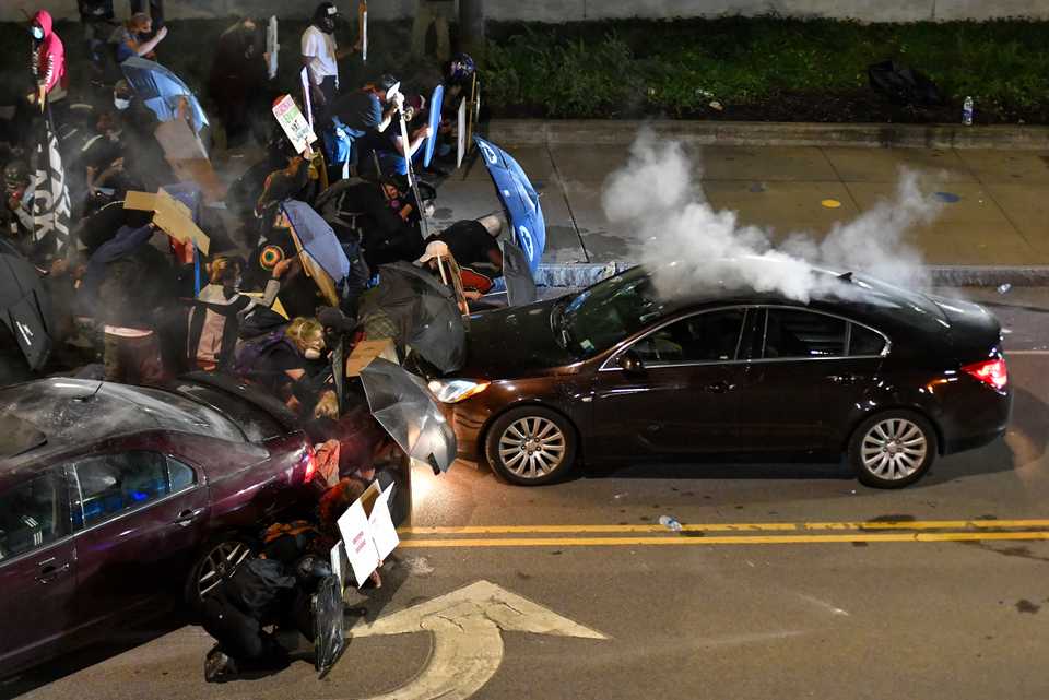 Demonstrators clash with police officers a block from the Public Safety Building in Rochester, NY, September 4, 2020, after a rally and march protesting the death of Daniel Prude.