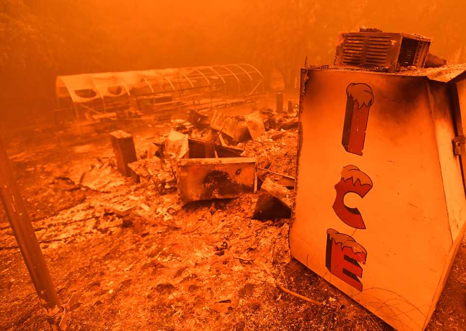 A singed ice machine sits over a burned store in Butte County, California.