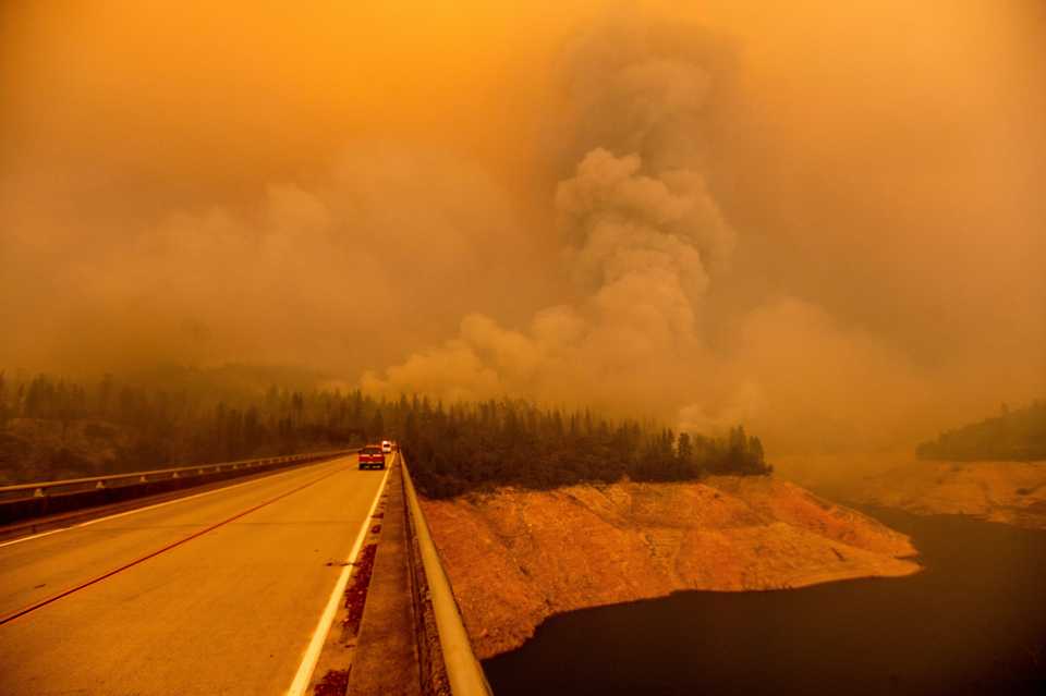A plume rises from the Bear Fire as it burns along Lake Oroville on Wednesday, Sept. 9, 2020, in Butte County, Calif.