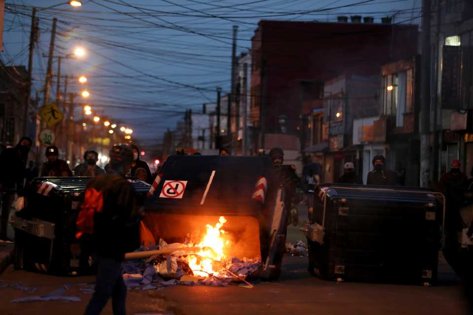 Demonstrators make a barricade with garbage bins during in Bogota, Colombia, September 10, 2020.