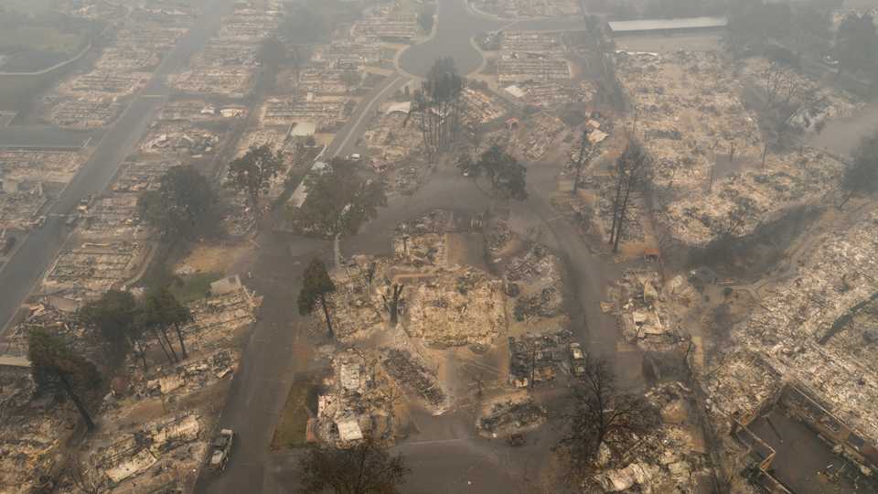A haze from wildfire smoke lingers over the gutted Medford Estates neighbourhood in the aftermath of the Almeda fire in Medford, Oregon, US, September 11, 2020. Image taken with a drone.