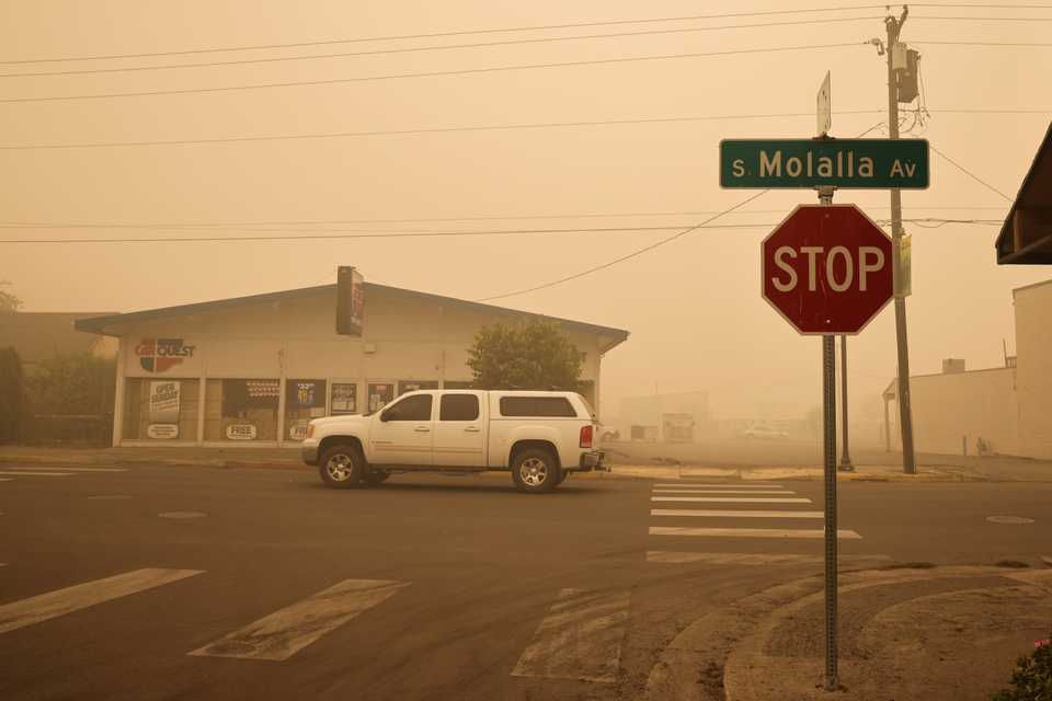 Local residents drive around the town where about 10,000 residents were evacuated as the fire continues, in Molalla, Oregon, US, September 11, 2020.