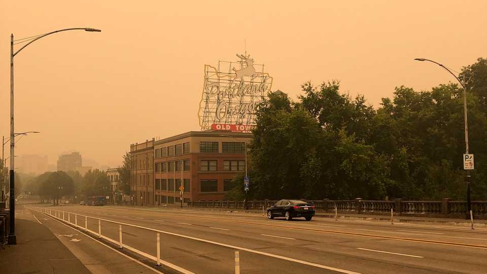 The Portland Oregon Old Town sign is seen under heavy smoke from the wildfires creating an orange glow over Portland, Oregon, September 12, 2020.