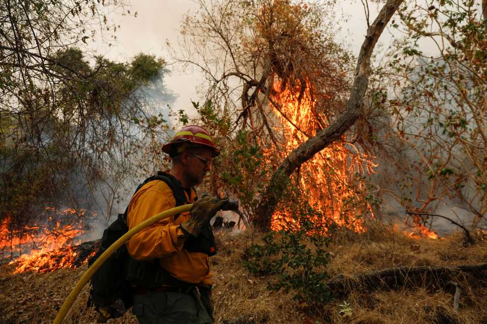A firefighter works to extinguish the Bobcat Fire after an evacuation was ordered for the residents of Arcadia, California, US, September 13, 2020.