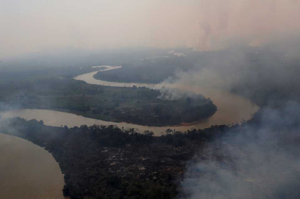 An aerial view shows smoke rising into the air around the Cuiaba river in the Pantanal, the world's largest wetland, in Pocone, Mato Grosso state, Brazil, August 28, 2020.