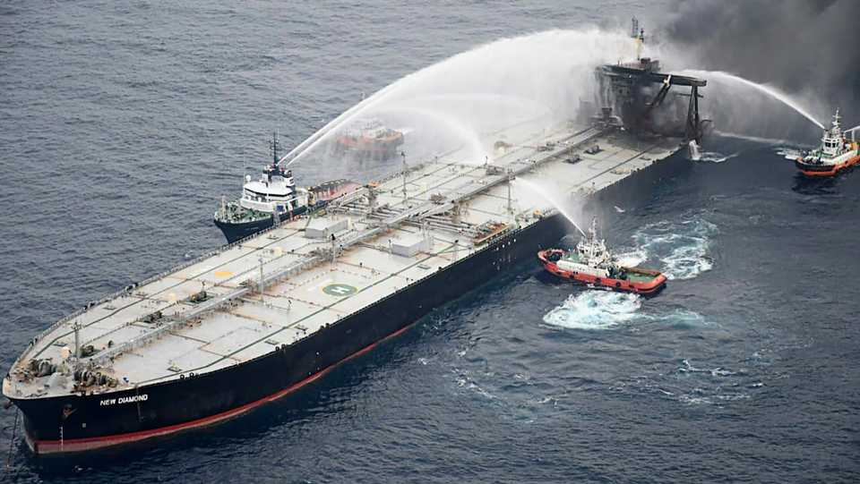 This handout photograph taken on September 8, 2020, and released by Sri Lanka's Air Force shows fireboats battling to extinguish a fire on the Panamanian-registered crude oil tanker New Diamond, some 60 km off Sri Lanka's eastern coast where a fire was reported inside the engine room. India on September 8 sent fresh supplies of firefighting chemicals to help battle a new blaze on a stricken tanker loaded with a massive cargo of crude oil off Sri Lanka's eastern coast.