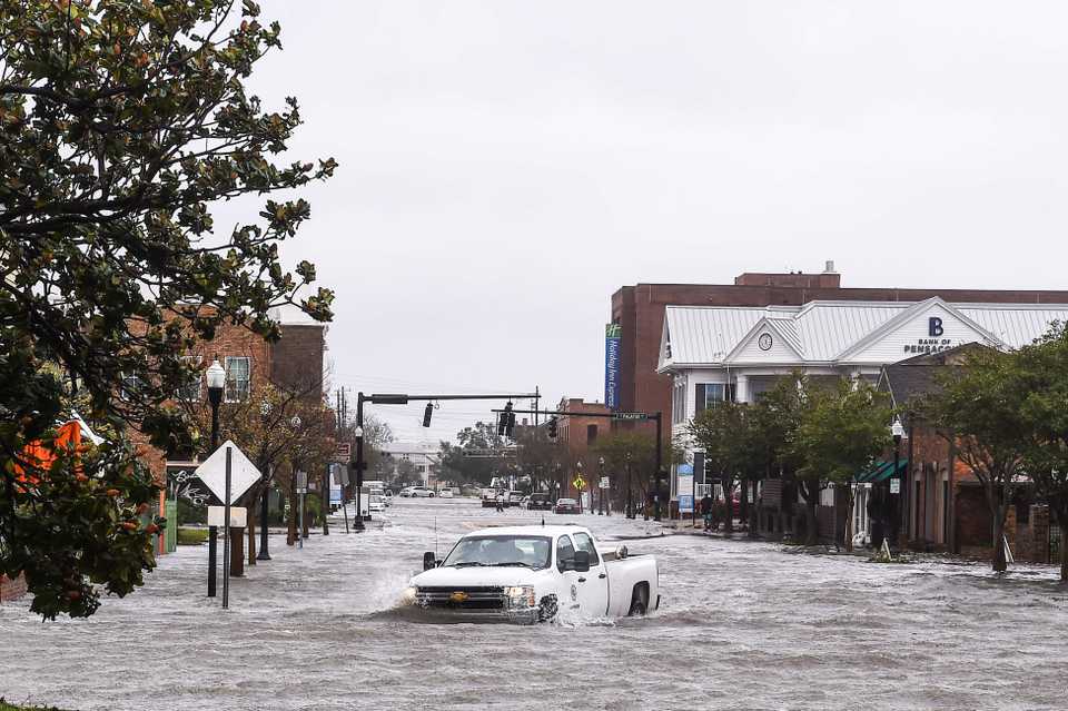 A city worker drives through the flooded street during Hurricane Sally in downtown Pensacola, Florida on September 16, 2020.