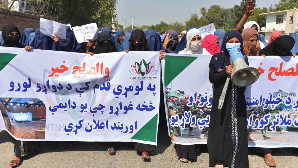 Afghan women protesters hold banners and chant slogans during a march to show their support towards peace talks between Afghan government and the Taliban. September 16, 2020.