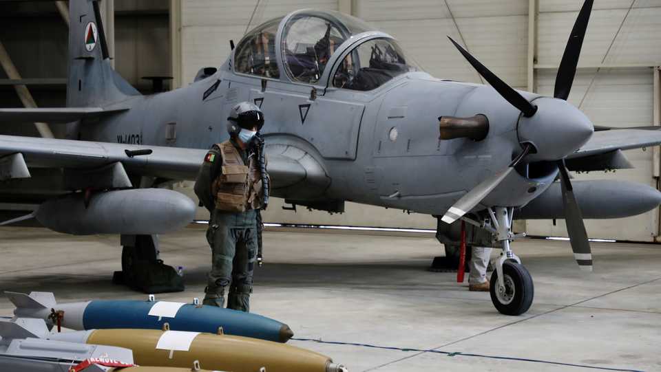 An Afghan pilot stands next to A-29 Super Tucano plane during a handover ceremony of A-29 Super Tucano planes from US to the Afghan forces, in Kabul, Afghanistan September 17, 2020.