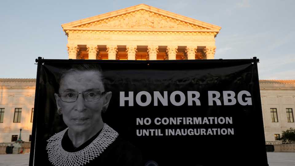 A banner with an image of the late US Supreme Court Justice Ruth Bader Ginsburg and a message referring to the selection of her successor is displayed outside the US Supreme Court in Washington, US, September 19, 2020.