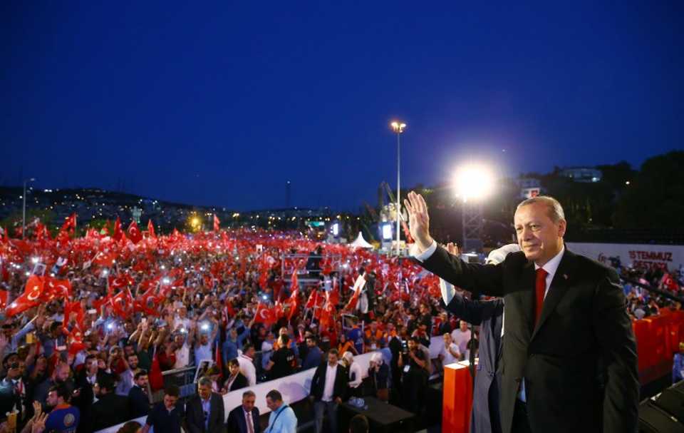 Turkish President Recep Tayyip Erdogan greets his supporters as they arrive for a ceremony marking the first anniversary of the attempted coup at the Bosphorus Bridge in Istanbul, Turkey July 15, 2017. 