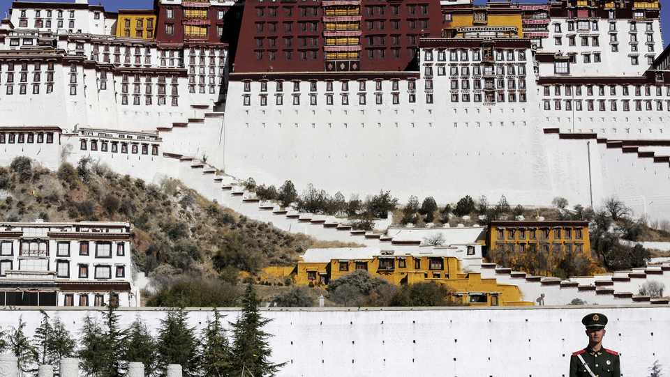 A paramilitary policeman stands guard in front of the Potala Palace in Lhasa, Tibet Autonomous Region, China on November 17, 2015.