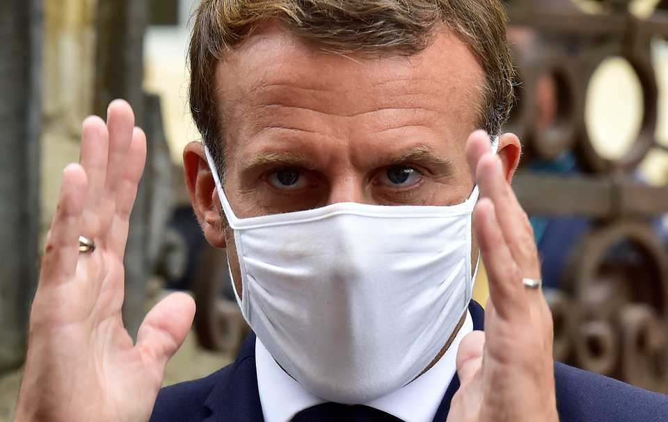 French President Emmanuel Macron wearing a protective face mask against the conoravirus speaks to the media as he visits the castle of Polignac at the eve of the heritage day in Condom, southwestern France, Friday, Sept. 18, 2020.
