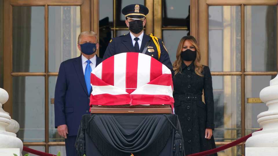 US President Donald Trump and first lady Melania Trump pay respects as Justice Ruth Bader Ginsburg lies in repose at the Supreme Court building, September 24, 2020, in Washington.