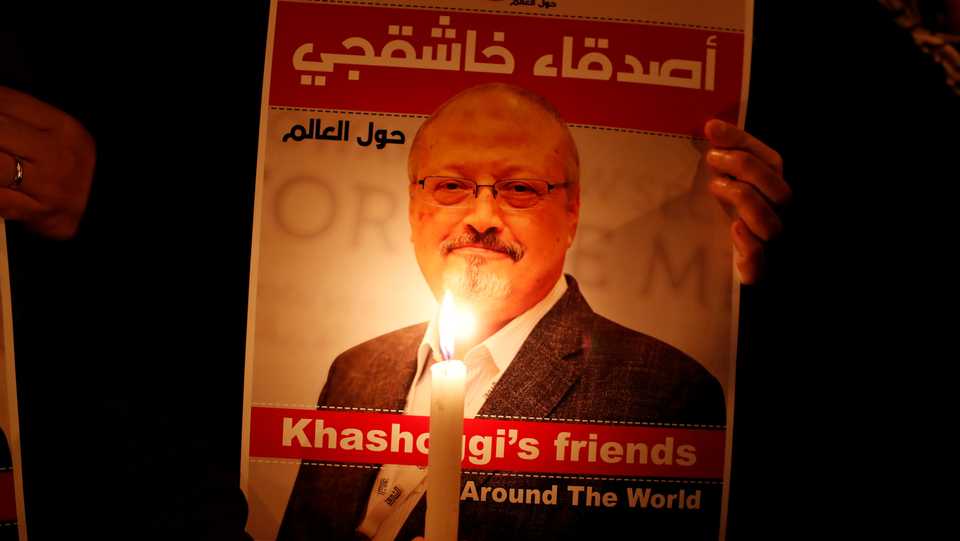 A demonstrator holds a poster with a picture of Saudi journalist Jamal Khashoggi outside the Saudi Arabia consulate in Istanbul, Turkey. October 25, 2018.