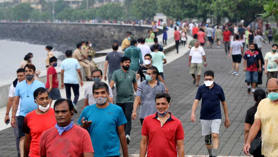 People stroll along the promenade at Marine Drive, amidst the coronavirus disease, in Mumbai, India, September 22, 2020.
