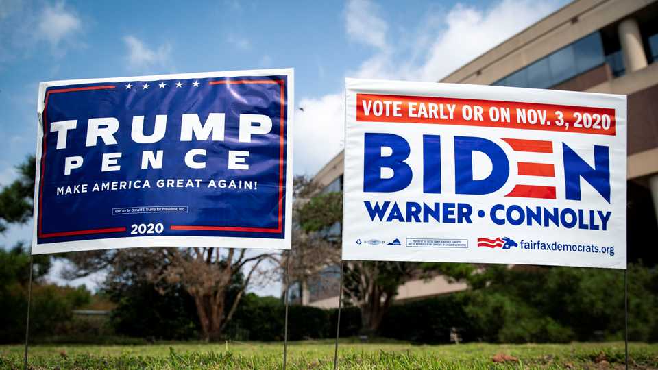 Yard signs supporting US President Donald Trump and Democratic US presidential nominee and former Vice President Joe Biden are seen outside of an early voting site at the Fairfax County Government Center in Fairfax, Virginia, US, September 18, 2020.