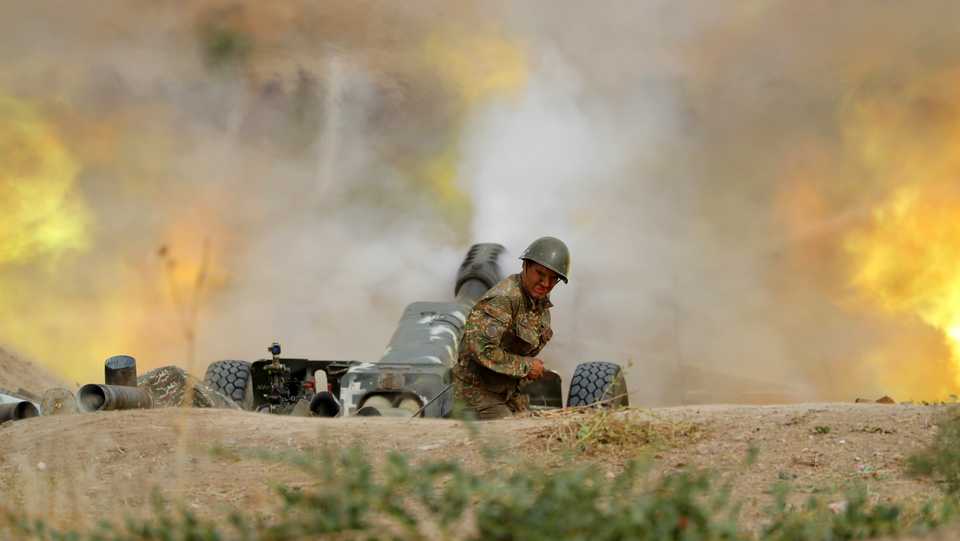 Armenian forces in occupied Karabakh fire an artillery piece towards Azerbaijan's positions during fighting over the occupied region on September 28, 2020.