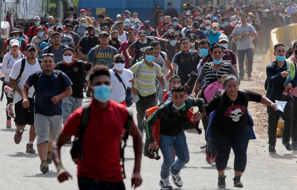 Migrants attempt to cross the border from Corinto, Honduras, into Corinto, Guatemala, on October 1, 2020.