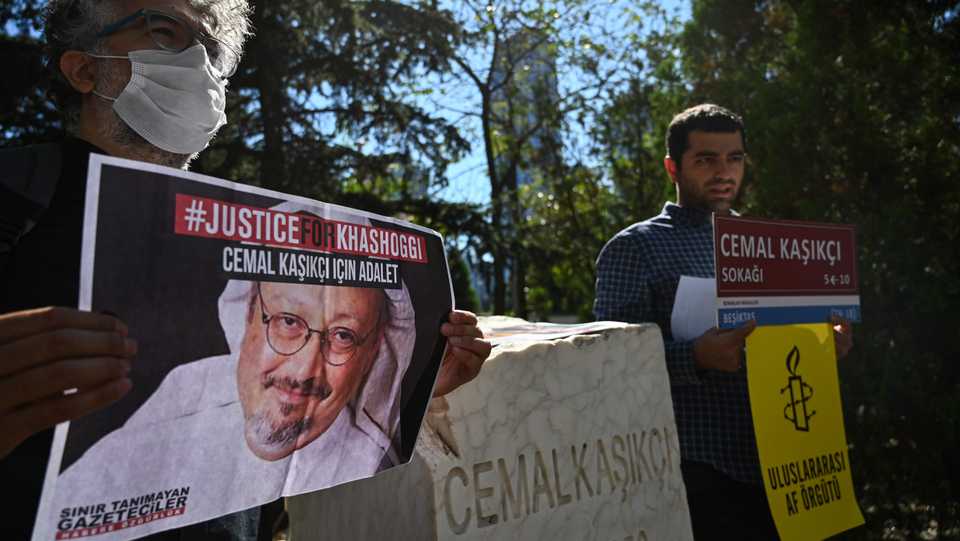 A representative of Reporters Without Borders (RSF) in Turkey holds a poster of murdered Saudi journalist Jamal Khashoggi during an event marking the second-year anniversary of the assassination of the Riyadh critic in front of Saudi Arabia's Consulate in Istanbul. October 2, 2020.