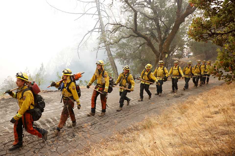 Members of the Cal Fire San Mateo - Santa Cruz Unit (CZU) march along Old Lawley Toll Road during the Glass fire in Calistoga, California, US, October 2, 2020.
