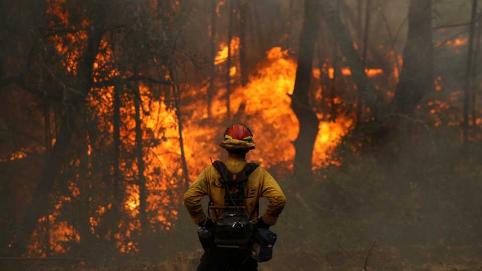 A Cal Fire firefighter monitors a firing operation while battling the Glass Fire in Calistoga, California, US October 2, 2020.