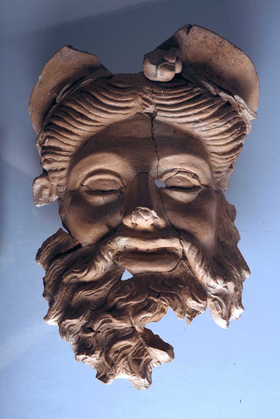 The restored terracotta mask presumed to be of Dionysus.