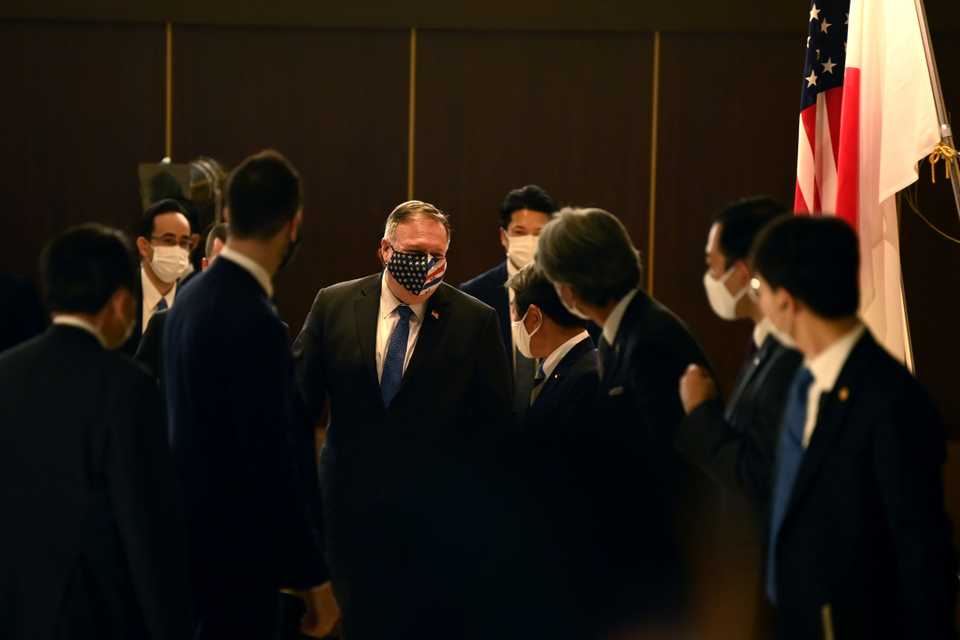 Japan's Foreign Minister Toshimitsu Motegi, centre right, greets US Secretary of State Mike Pompeo, centre left, prior to their bilateral meeting in Tokyo on October 6, 2020.