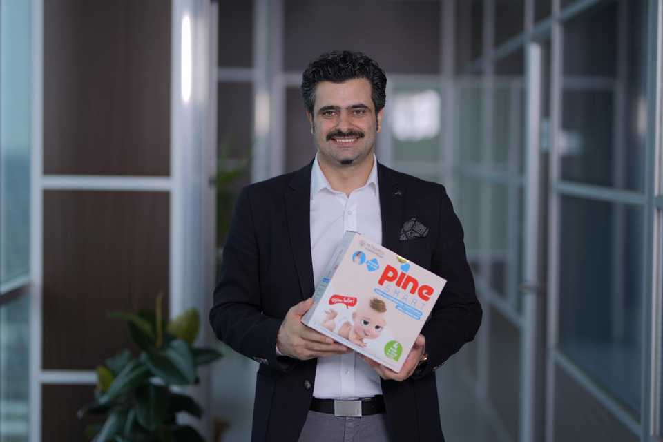 CEO of Arkan Group Ozcan Arkan holding a pack of smart diapers that can detect urinary tract infections in babies.