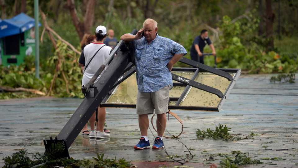 A tourist speaks on his phone outside a shelter after the passage of Hurricane Delta in Cancun, Quintana Roo state, Mexico, on October 7, 2020.