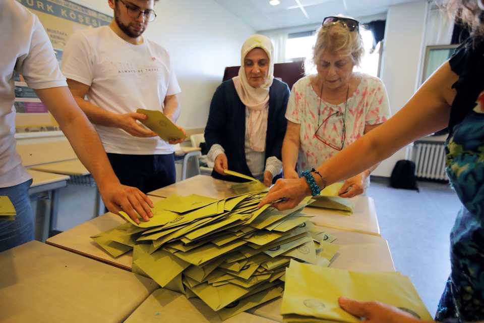 Election officials open a ballot box to count votes at a polling station in Istanbul, Turkey, June 23, 2019.