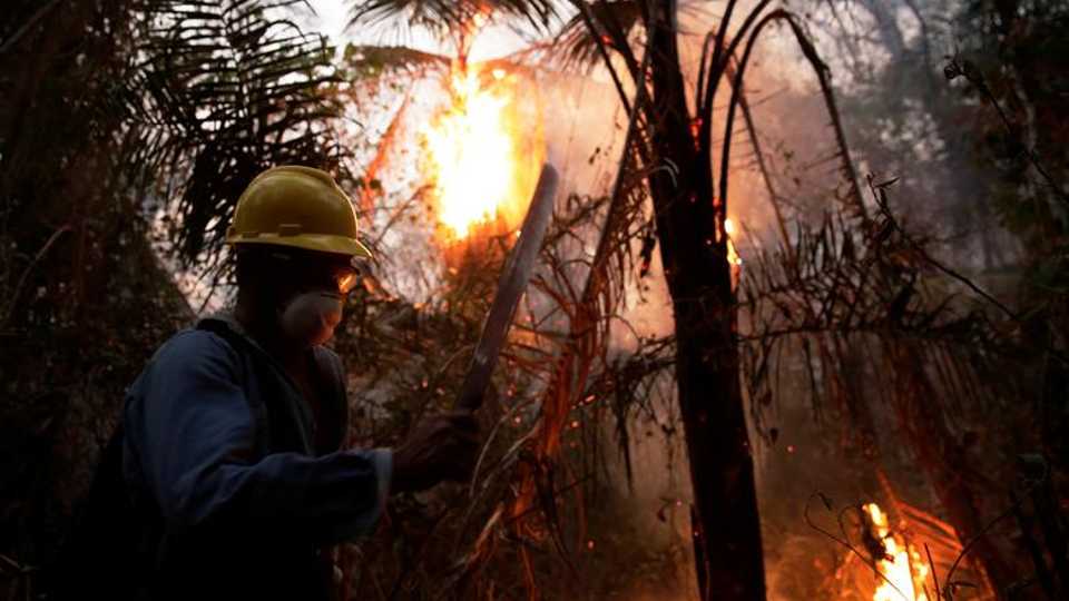 A man fights wildfires in Santa Monica near Concepcion, Bolivia, on September 21, 2019.