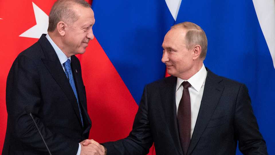 Russia's President Putin and Turkey's President Erdogan shake hands during a news conference following their talks in Moscow, Russia, March 5, 2020.