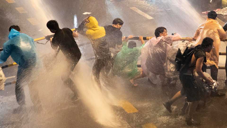 Demonstrators face water cannons as police try to clear the protest venue in Bangkok, Thailand, on October16, 2020.