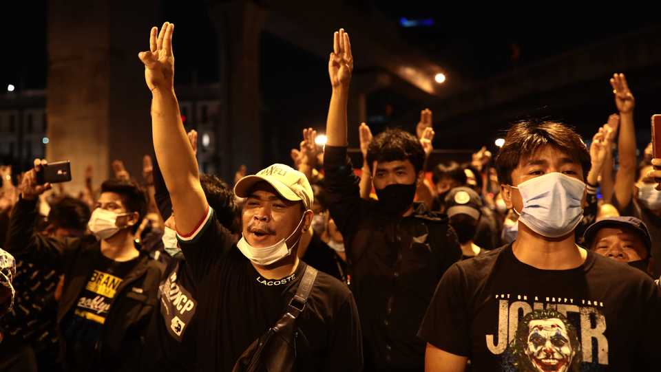 Pro-democracy protesters give the three-finger salute during an anti-government rally at Udomsuk in Bangkok on October 17, 2020, as they continue to defy an emergency decree banning gatherings.