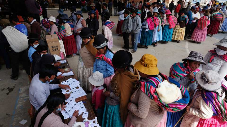 People line up to cast their votes at a polling station during the presidential election, in Cohoni, Bolivia October 18, 2020.