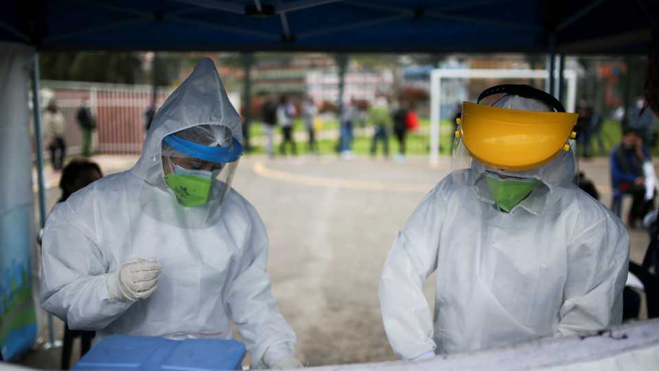 Members of a medical team prepare items for practice Covid-19 tests in Bogota, Colombia, July 14, 2020.