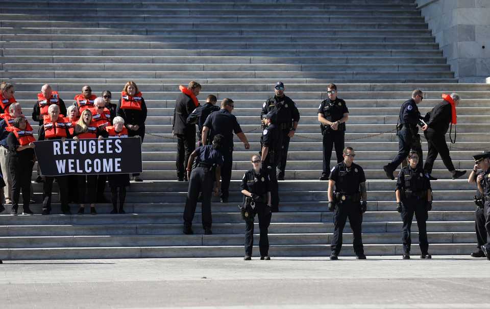 People are detained on the steps of the U.S. Capitol Building during a demonstration against planned Trump administration cuts to the US refugee resettlement program, in Washington, US, October 15, 2019.