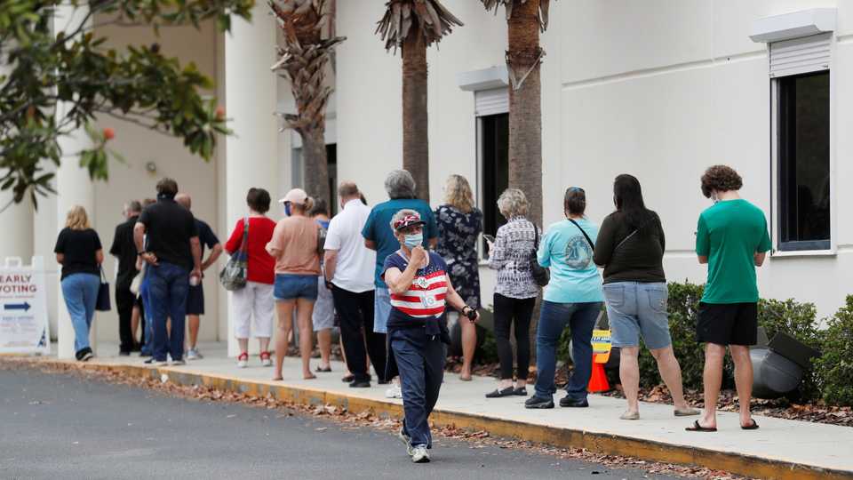 People line up at the Supervisor of Elections Office polling station as early voting begins in Pinellas County ahead of the election in Largo, Florida, US, October 21, 2020