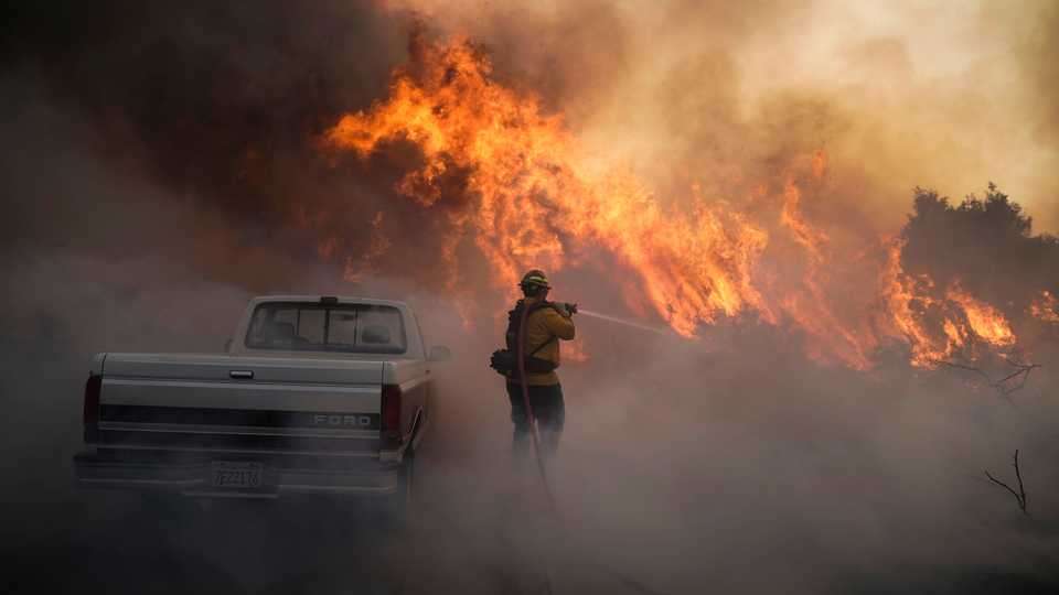 A firefighter battles the Silverado Fire on Monday, October 26, 2020, in Irvine, California.