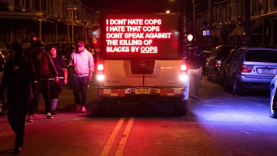 A truck displays a sign as protesters march in West Philadelphia on October 27, 2020, to demonstrate against the fatal shooting of 27-year-old Walter Wallace, a Black man, by police.