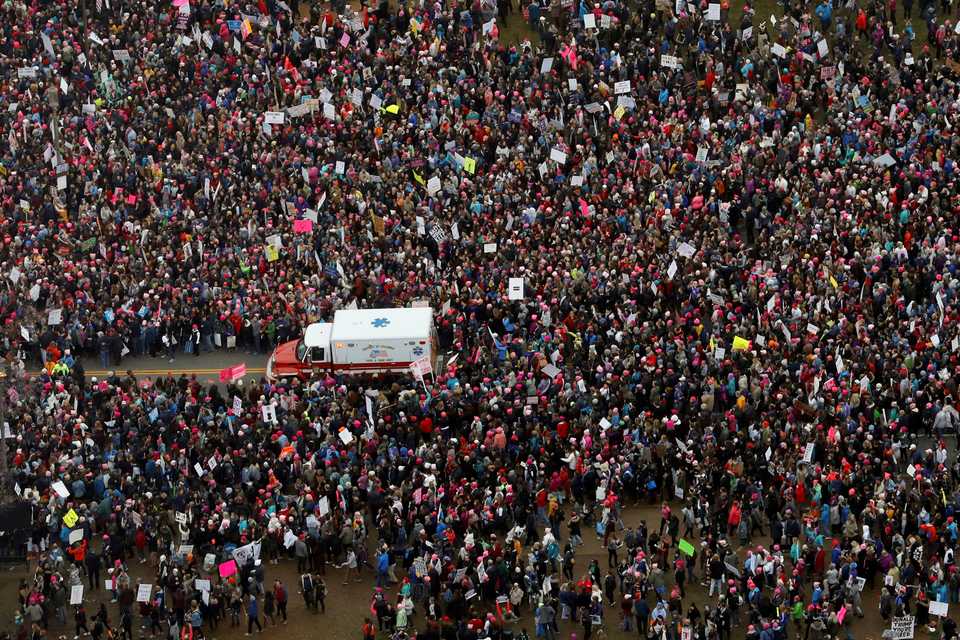 An ambulance drives through protesters on the National Mall during the Women's March on Washington during the first full day of Donald Trump's presidency, Saturday, Jan. 21, 2017 in Washington DC.